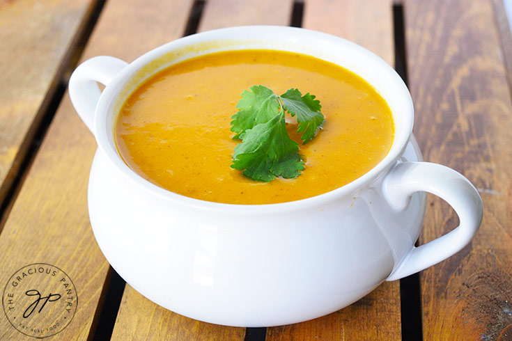 The finished Curried Sweet Potato Soup in a white crock.