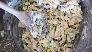 Mixing all the ingredients in this Healthy Tuna Pasta Salad Recipe together in a stainless steel mixing bowl.