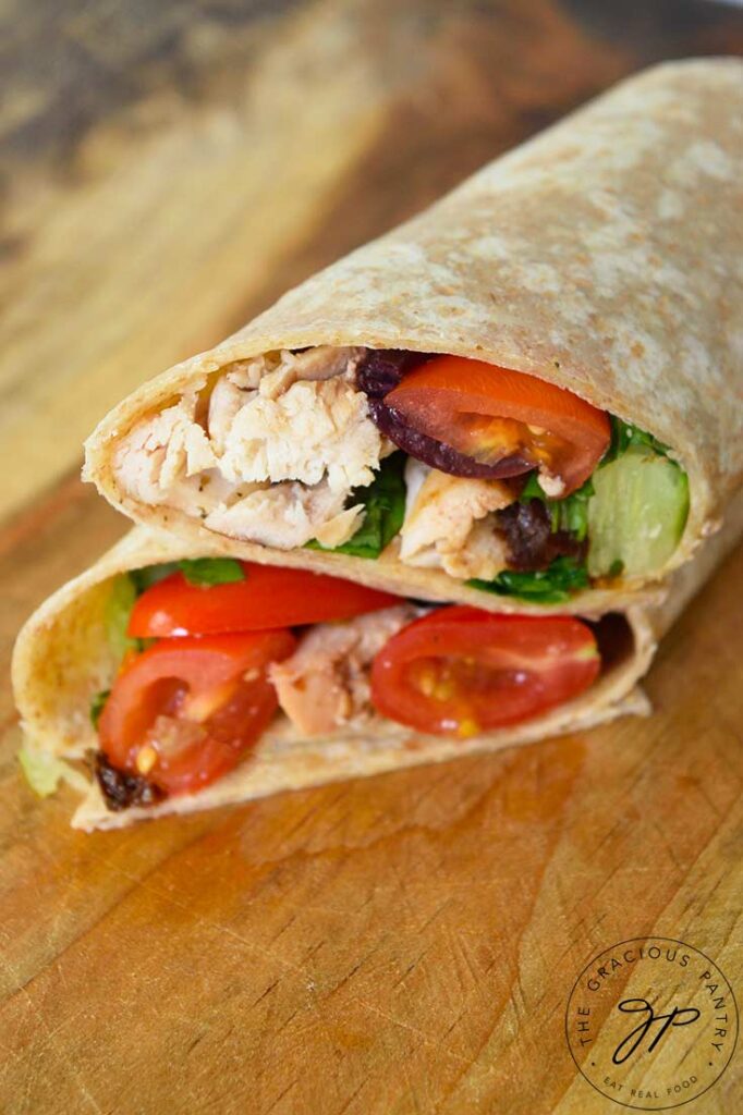A top down view of a cut, Italian chicken wrap that has been stacked.