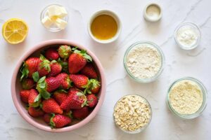 All the ingredients for this Healthy Strawberry Crumb Bars Recipe measured and gathered on a white surface.