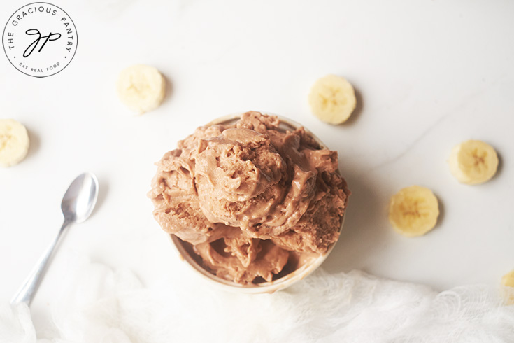 Chocolate Banana Nice Cream served in a white bowl with a spoon.