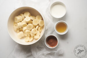 Chocolate Banana Ice Cream Recipe ingredients in individual white bowls.