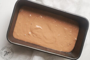 Chocolate Banana Nice Cream poured into a loaf pan and sitting on a white surface.