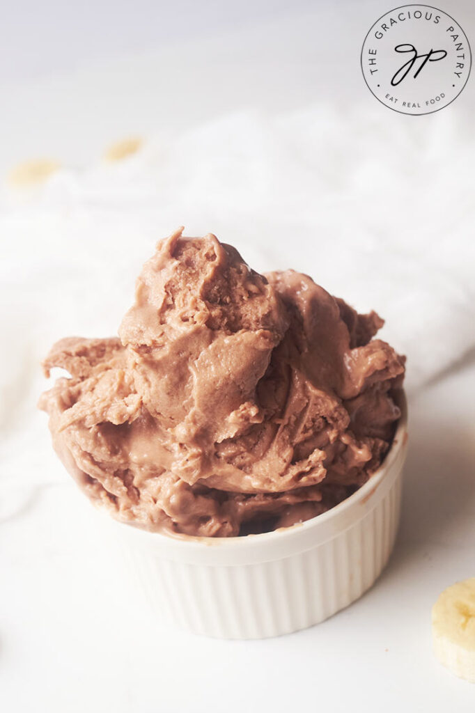 A side view of a white bowl filled with Chocolate Banana Nice Cream.