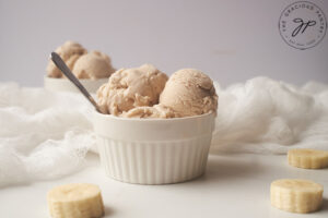 The finished Coconut Banana Ice Cream, scooped into a white bowl.