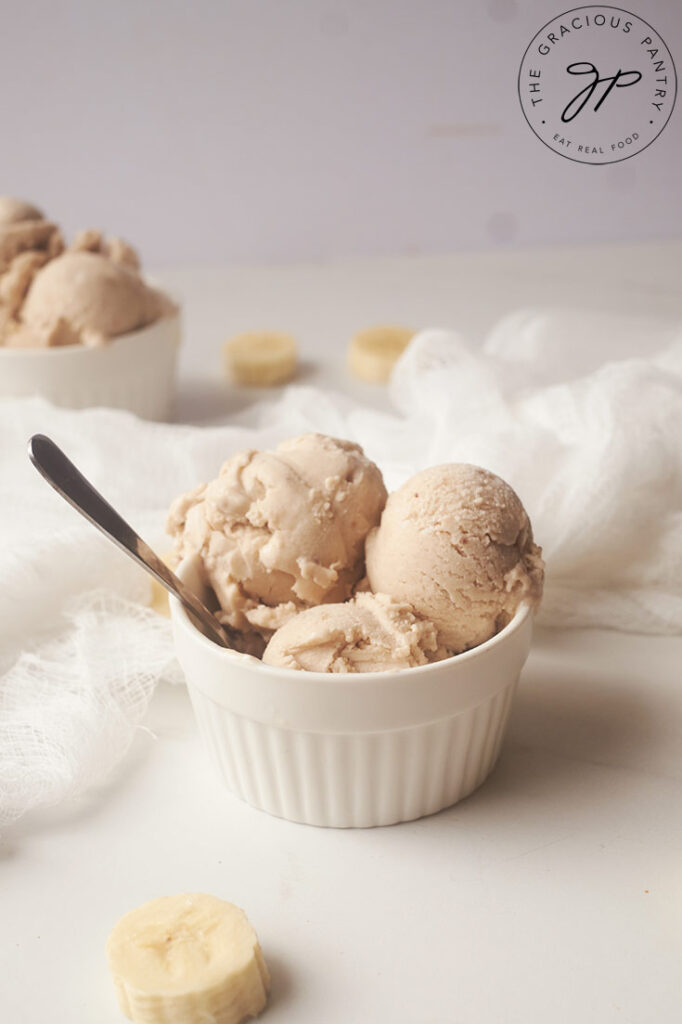 Three scoops of Coconut Banana Ice Cream in a white bowl.