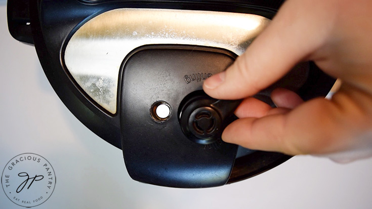 Closing the lid and steam valve on an Instant Pot.