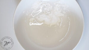 A white bowl with water and arrowroot powder in it.