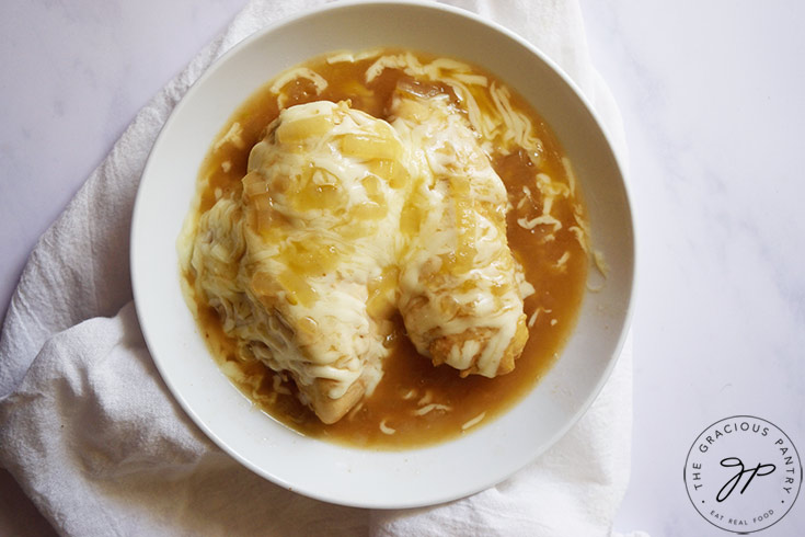 A while bowl holds the finished French Onion Chicken dish.