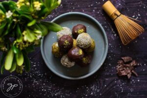 An overhead view looking down onto a gray plate holding several Matcha Energy Balls.