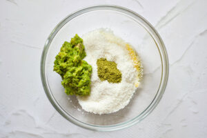 All the Matcha Energy Balls Recipe ingredients sitting in a glass mixing bowl.