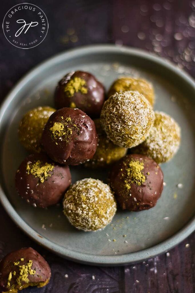 An overhead view looking down on a gray plate holding a stack of matcha energy balls.