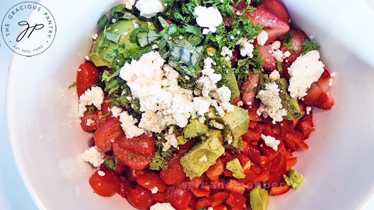 A mixing bowl filled with all the ingredients for this Summer Quinoa Salad Recipe.