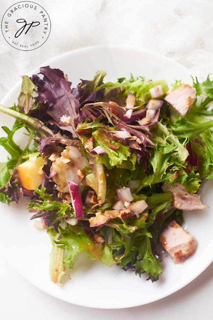 An overhead view of a Chicken Apple Salad on a white plate.