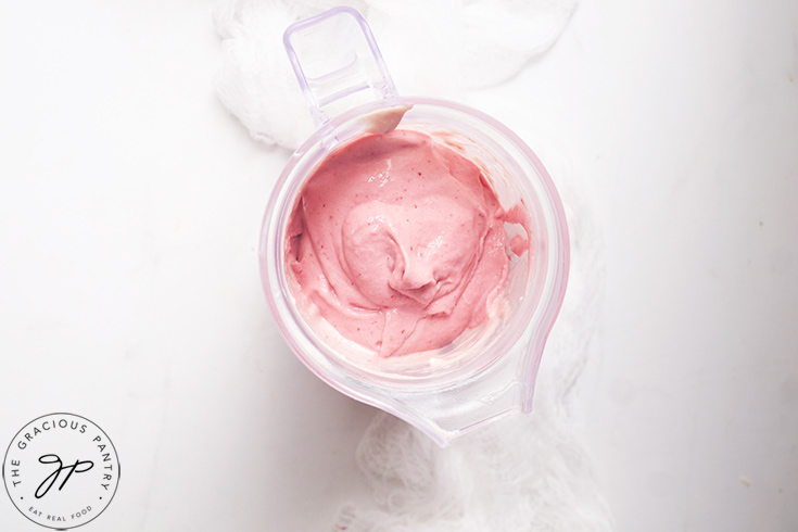 Blended Healthy Strawberry Ice Cream sitting in a blender tumbler.