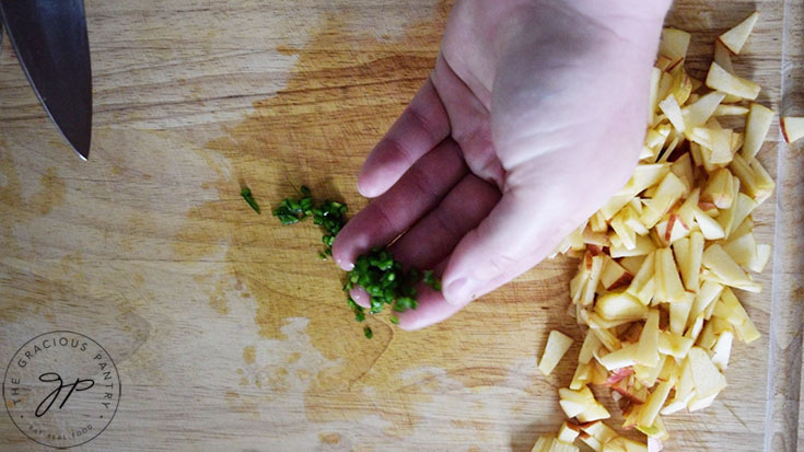 Minced jalapeno pepper on a cutting board.