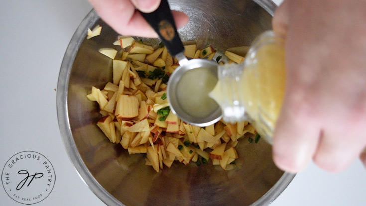 Adding lemon juice to the apple salsa.