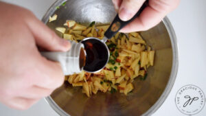 Adding maple syrup to the apple salsa.