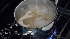 Pasta boiling in a pot on a stove.