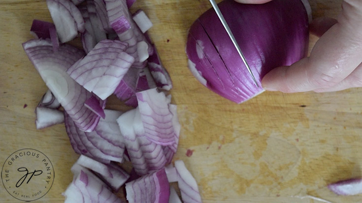 A purple onion being chopped.