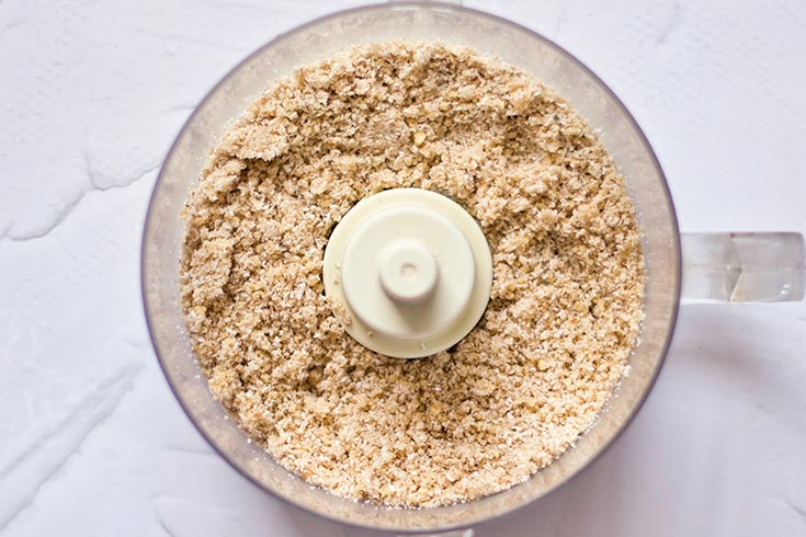 Blended Gluten-Free Carrot Cake crust in a food processor.