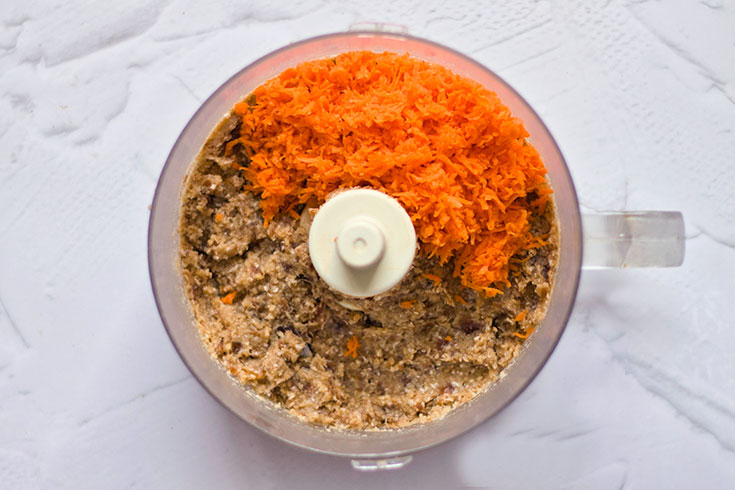 Carrots added to blended crust in a food processor.