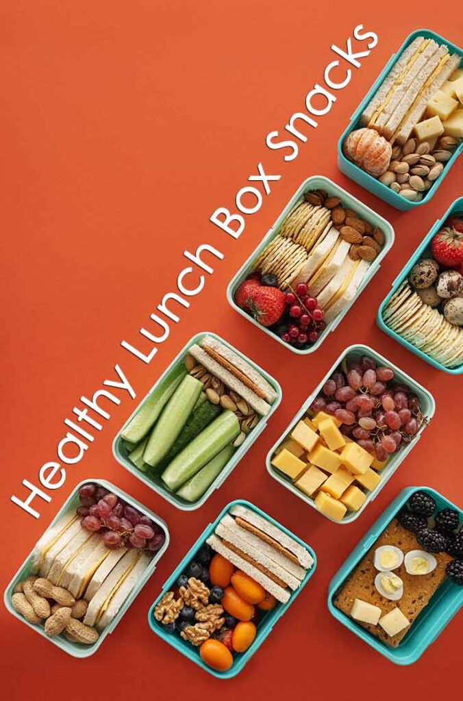 Several bento-style lunch boxes lined up at an angle on an orange background for this list of healthy lunchbox snack ideas.