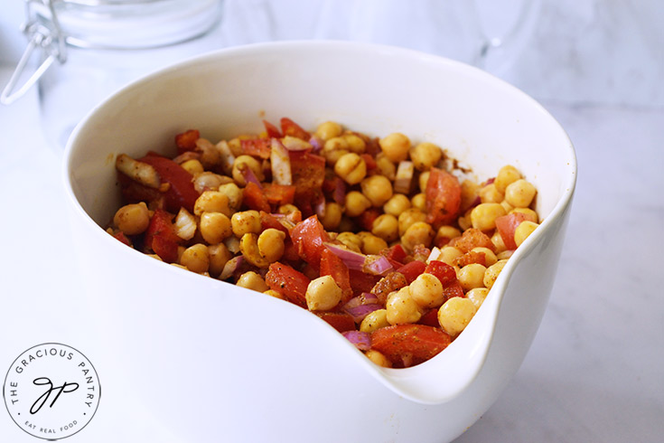 A white bowl holds the just-finished Indian Chickpea Salad.