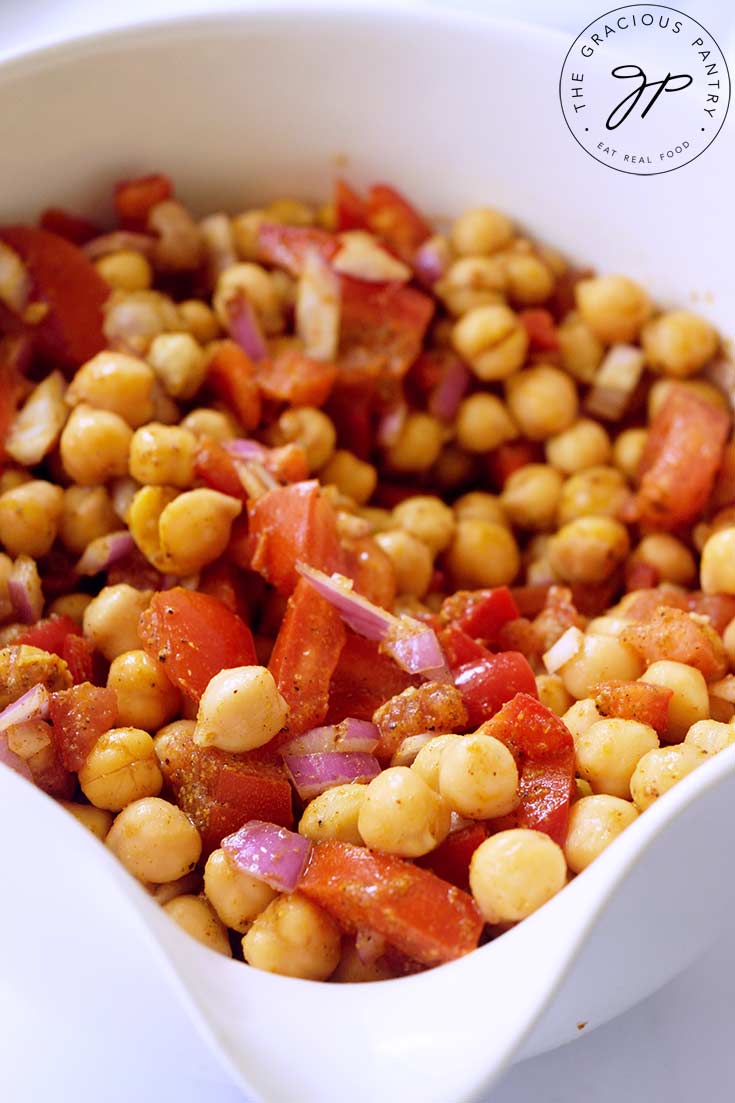 A close up of Indian Chickpea Salad in a white bowl.