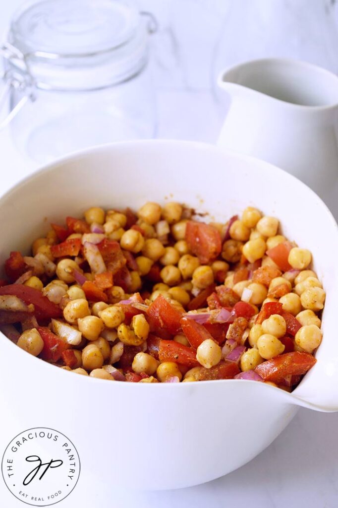 A side view of Indian Chickpea Salad in a white serving bowl.