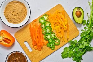 Sliced peppers on a wood cutting board.