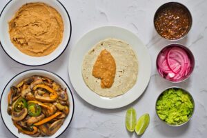 A tortilla with refried beans in the center.