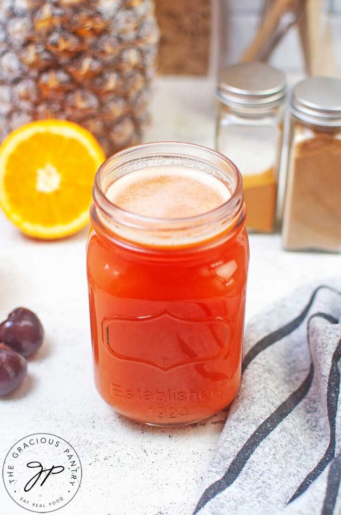 An angled view of an open canning jar filled with Immunity Booster Shots.