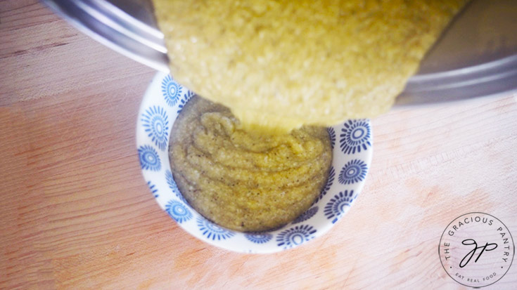 Pouring grits into a serving bowl.