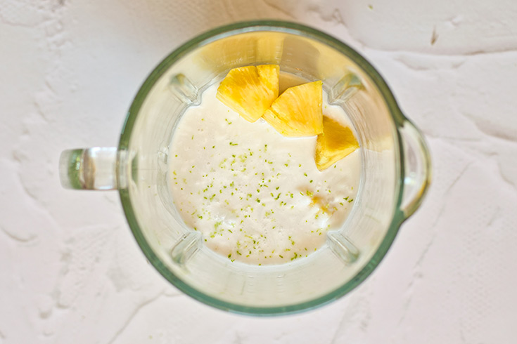 Pineapple Popsicle ingredients sitting in a blender tumbler.