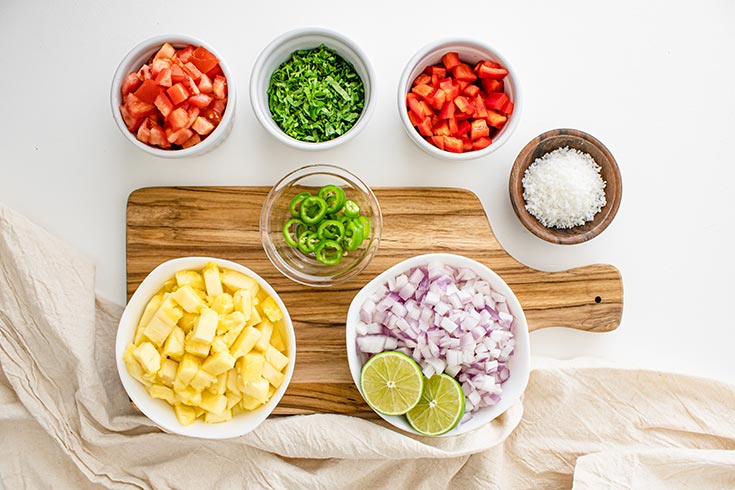 Pineapple Salsa ingredients chopped and sitting in individual bowls.