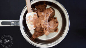 Canned refried beans in a pot.