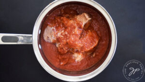 Canned refried beans and salsa in a pot.