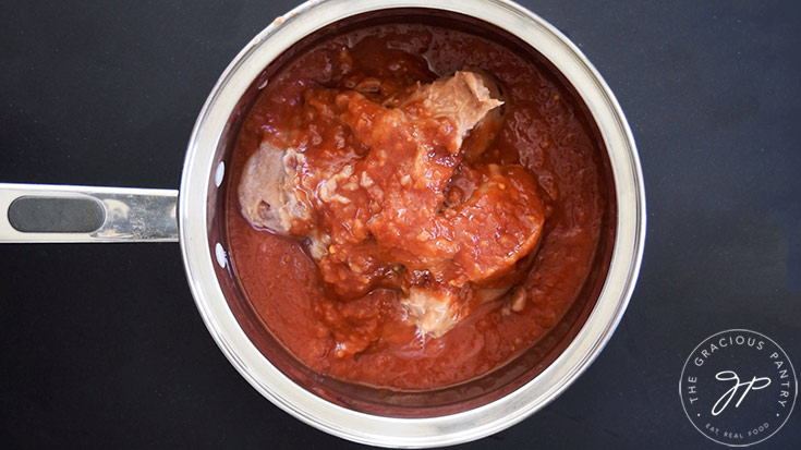 Canned refried beans and salsa in a pot.