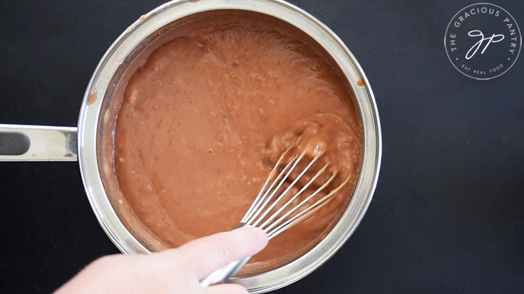 Refried Bean Soup being whisked together in a pot.