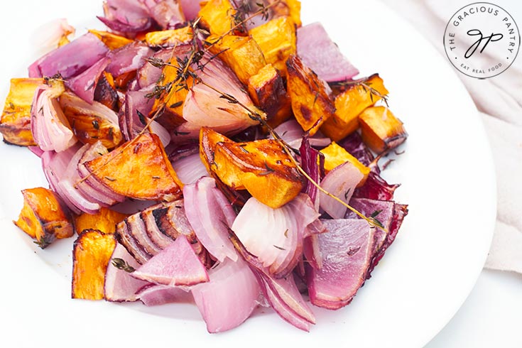 Herb And Garlic Roasted Sweet Potato Salad served on a white plate.