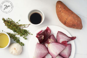 All the ingredients for this Herb And Garlic Roasted Sweet Potato Salad Recipe gathered on a white surface.