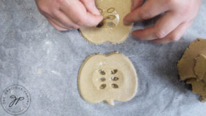 Picking out the vent holes in the pie crust with a toothpick.