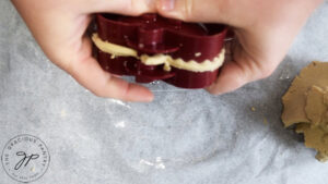 Pressing the pie crust together in the hand pie mold.