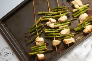 Just-baked chicken and vegetable kabobs on a sheet pan.
