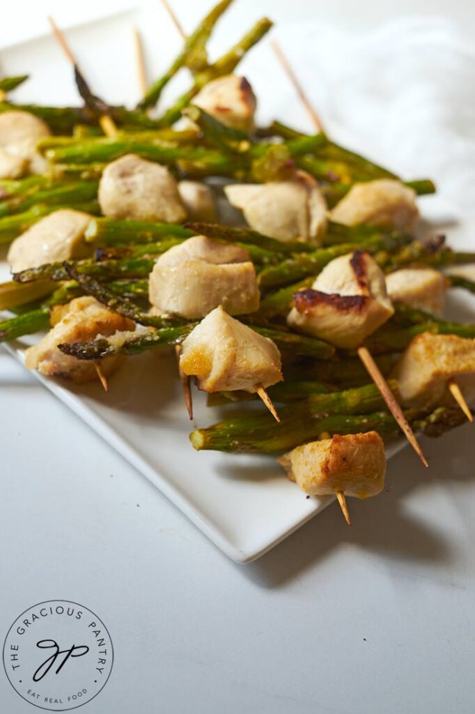 A white platter filled with Chicken Vegetable Kabobs.