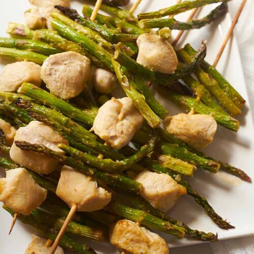 An overhead view of Chicken Vegetable Kabobs on a white platter.