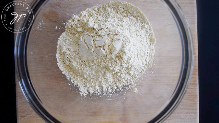 Chickpea flour sitting in a glass mixing bowl.