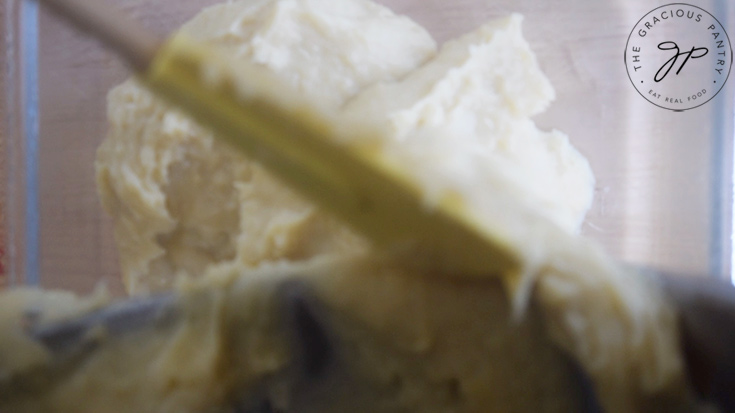 Chickpea Tofu batter being poured into an oiled, glass dish.