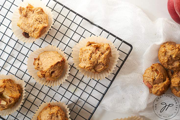 Cinnamon Apple Muffins cooling on a black, wire rack.